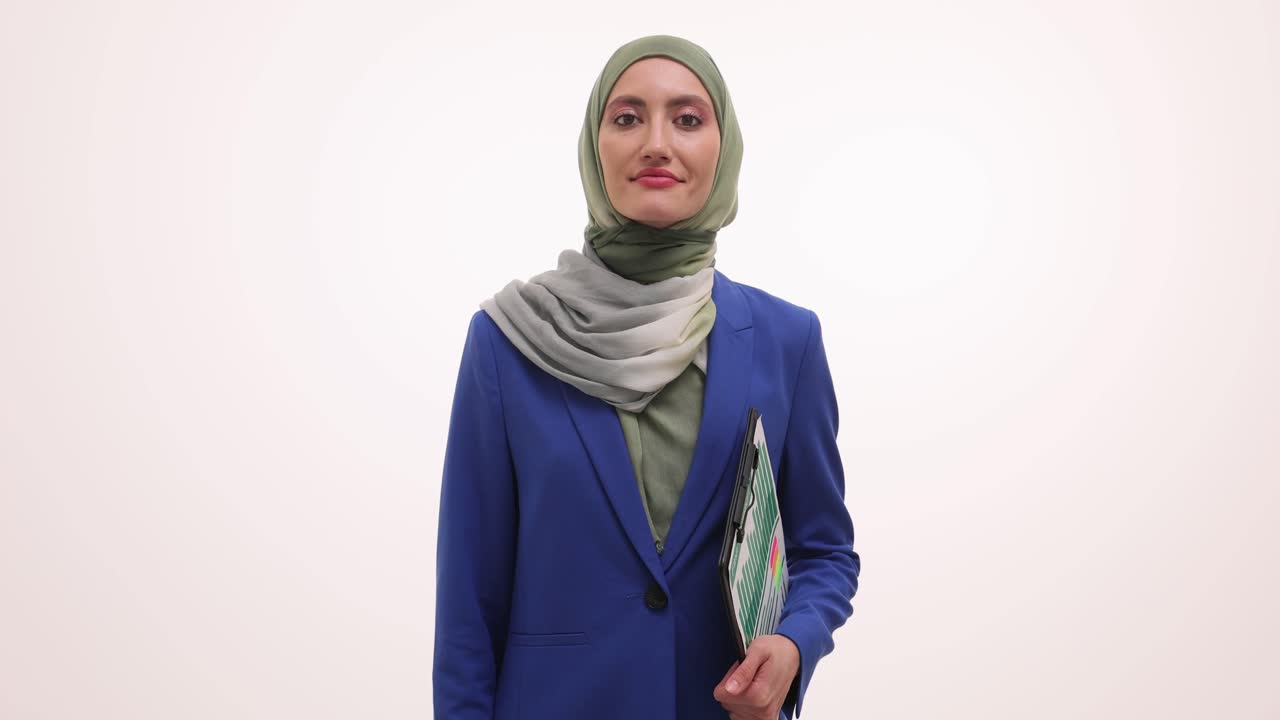 Muslim businesswoman in hijab waving hello