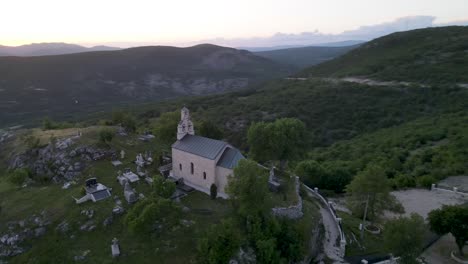 small hilltop church against beautiful green landscape , montenegro