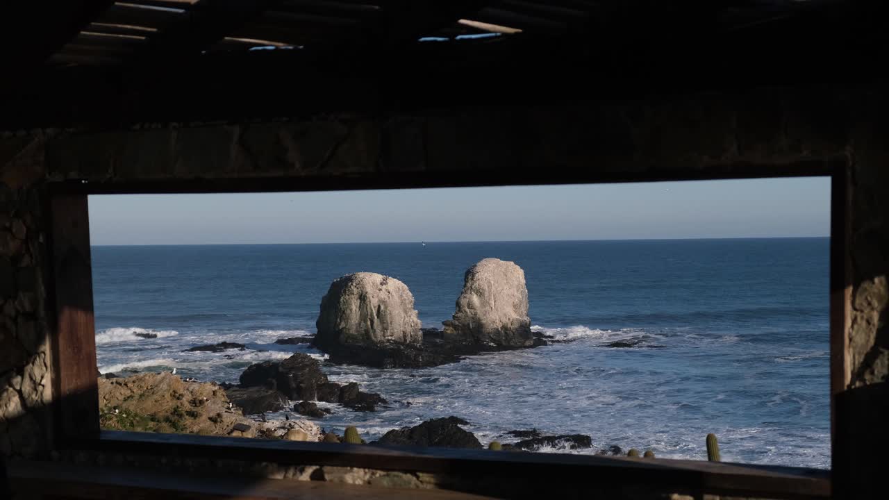 pandemic trip new way of traveling man looks through a frame or window towards punta de lobos surf point chile with face mask in the new normal of chile covid free