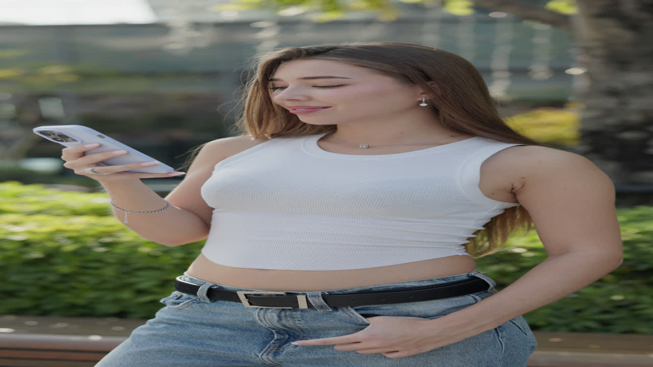 Young woman using her smartphone outdoors