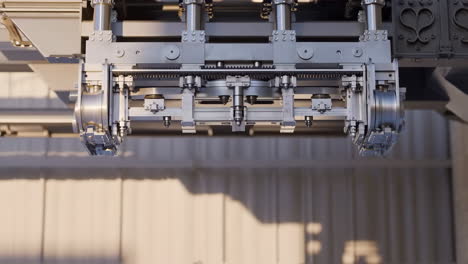 close-up of a complex industrial machine mechanism with gears and moving parts