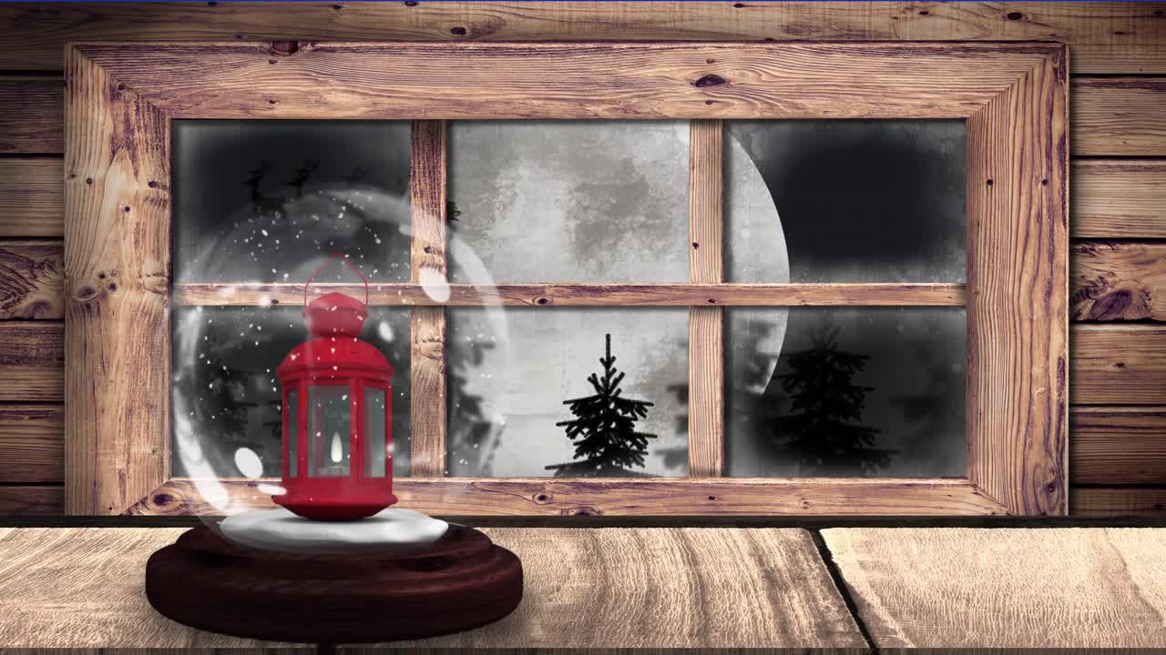 Animazione di una palla di neve con lanterna e sagoma di Babbo Natale su slitta.