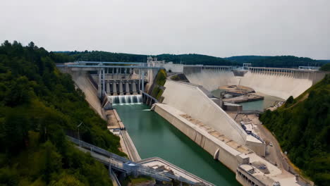 panoramic view of a hydroelectric dam with water flowing through spillways