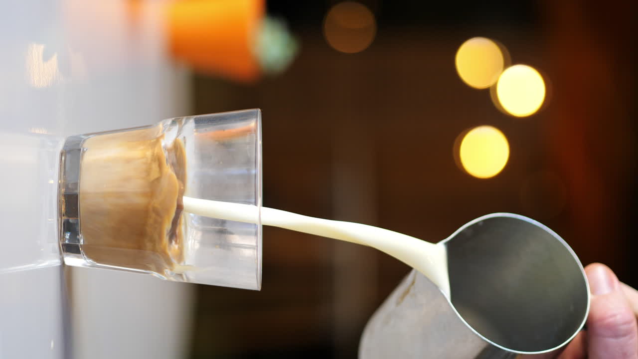 4K Loopable Gif, Jug Pours Milk into Clear Glass with Espresso Coffee, PORTRAIT