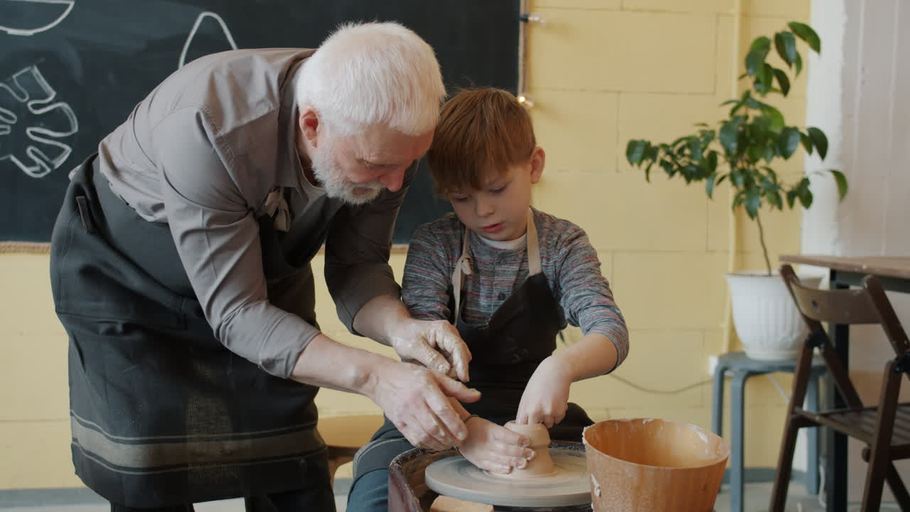 Grandfather and Grandson Learning Pottery Together