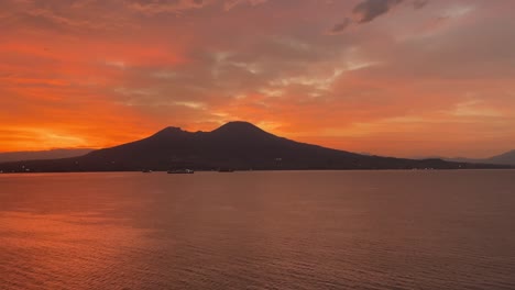 Silhouette-view-of-a-hill-and-the-tranquil-beauty-of-a-sunrise-bathes-everything-in-a-soft,-ethereal-orange-light