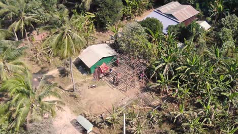 aerial clip of unfinished house under construction in battambang cambodia during a hot dusty summer day