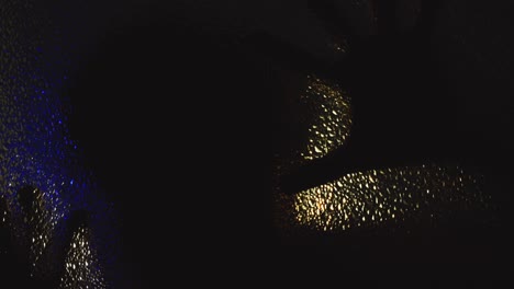 terrifying possessed man crawls on glass in the dark under flickering light
