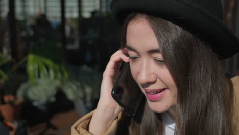 woman talking on phone in outdoor cafe