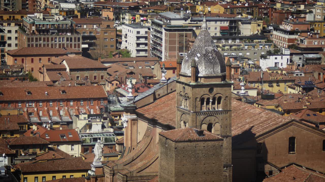 Aerial view of the bell tower of the cathedral of San Pietro in the background of the city of Bologna