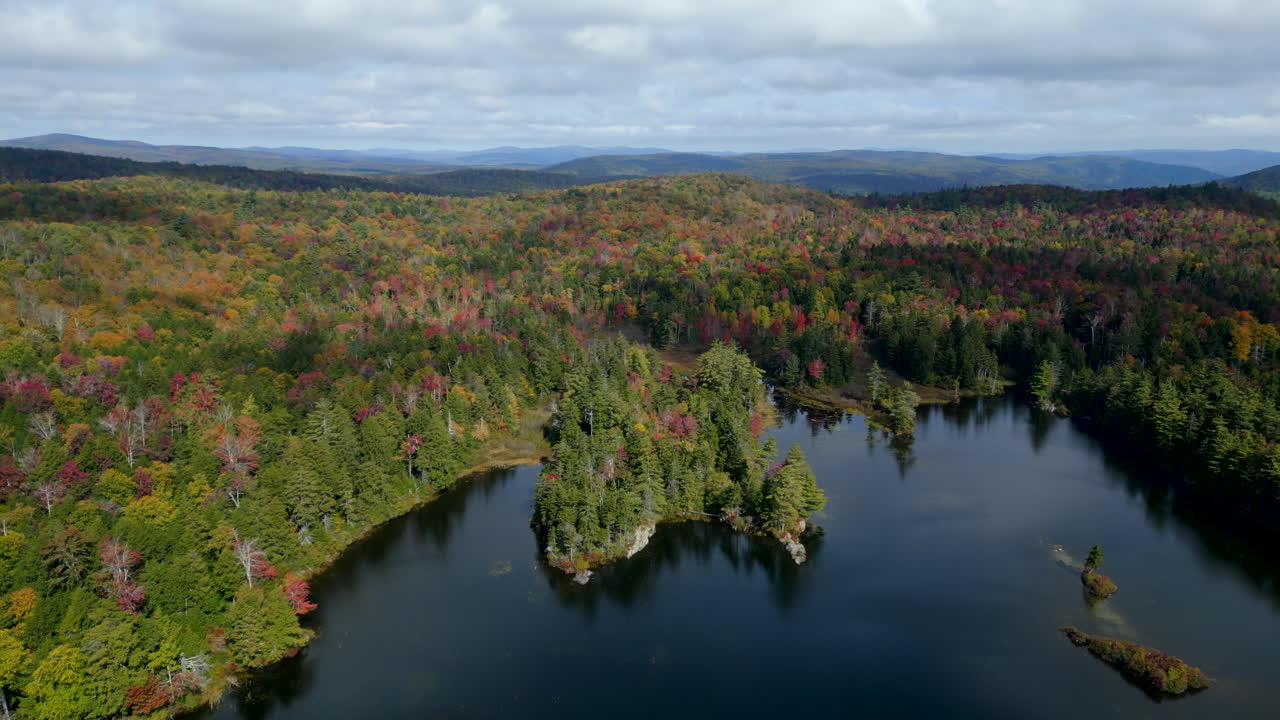 A breathtaking drone shot capturing the calm beauty of Plainfield Pond from above.