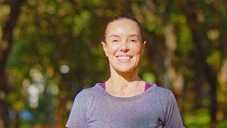 Smiling-stunning-woman-delighted-at-day-outside-in-nature-and-sunlight