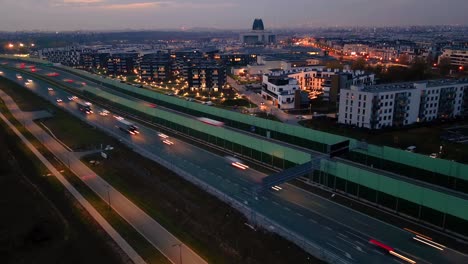 hyperlapse or dronelapse aerial view of highway road next to city warsaw, wilanow