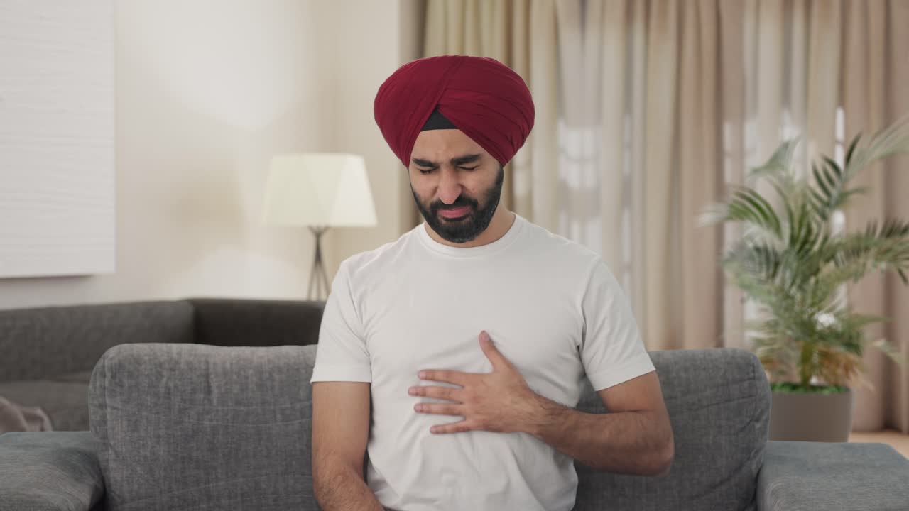 Sick Sikh Indian man suffering from acidity