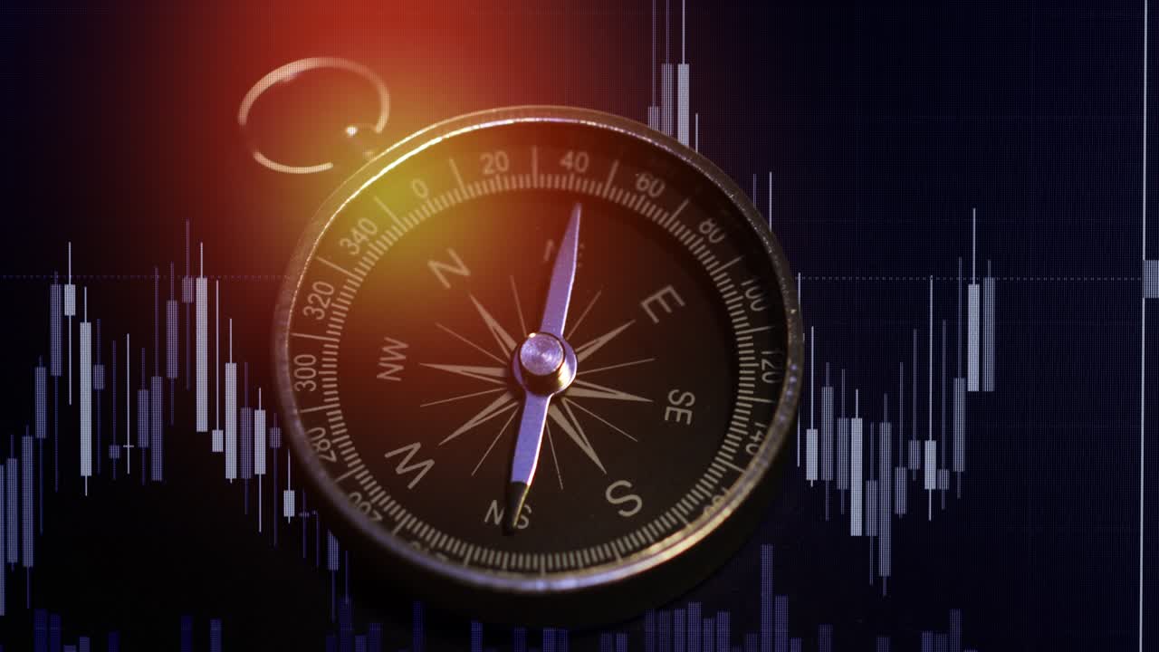 una toma de una brújula con gráfico de comercio