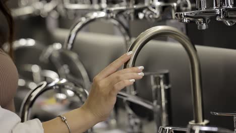 woman selecting a faucet in a showroom