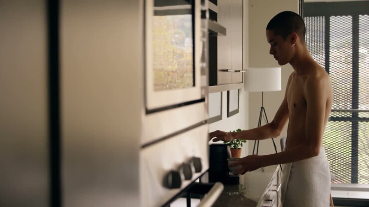 Man using coffee maker machine at home 4k