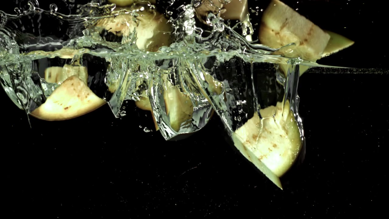 Eggplant Slices Falling into Water in Slow Motion