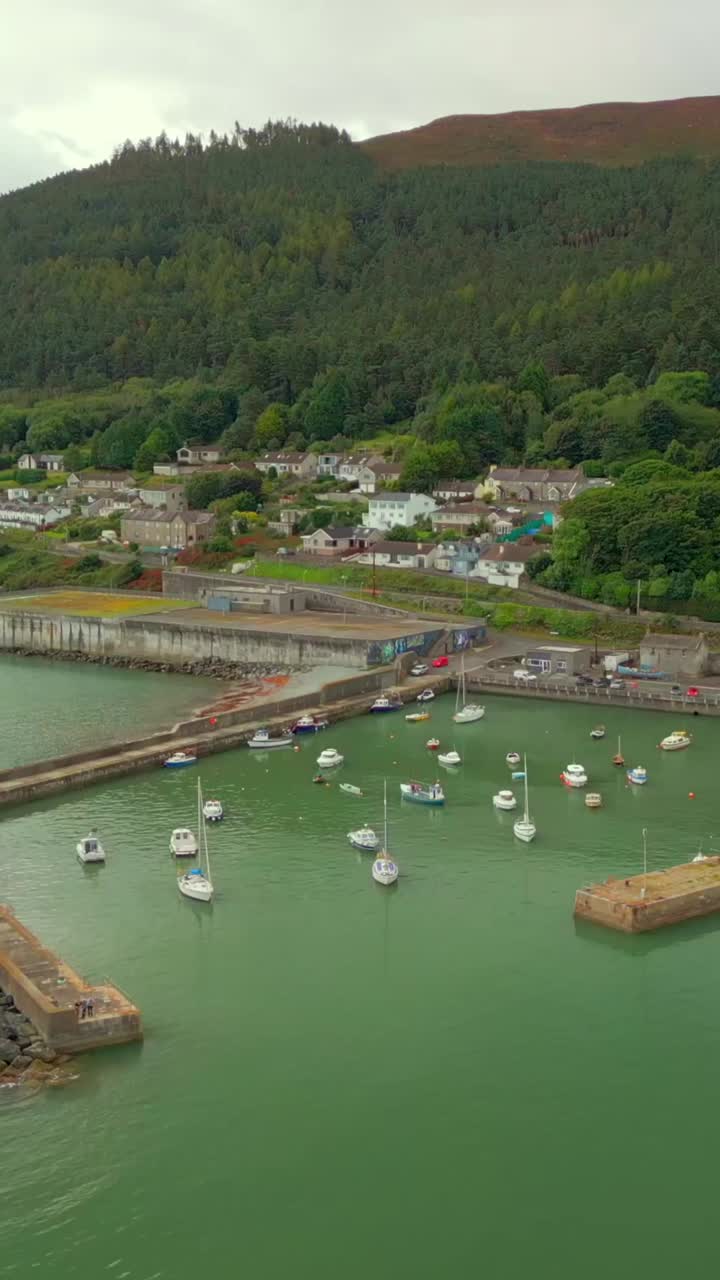Wide advancing social ratio aerial video GV of Newcastle Harbour in County Down, Northern Ireland. Produced in 1920x1080 social ratio, 60FPS and with Rec709 color