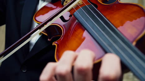 man playing violin outdoors