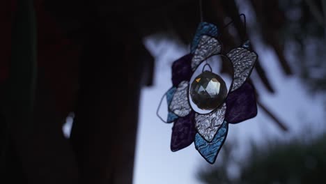 Close-up-of-turning-glass-lotus-flower-and-feng-shui-crystal-ball