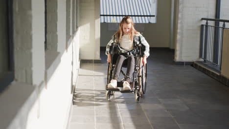 young girl in wheelchair navigating school hallway, determined and independent