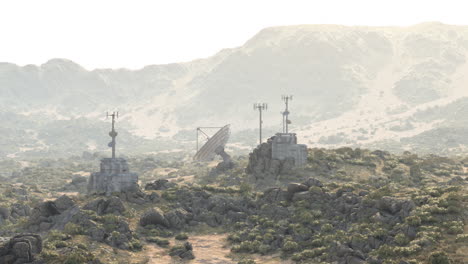 a satellite dish and communication towers in a desert landscape