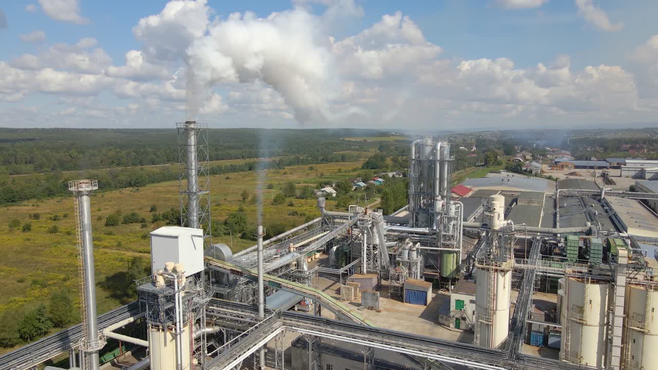 Aerial view of oil and gas refining petrochemical factory with high refinery plant manufacture structure. Global production and manufacturing concept