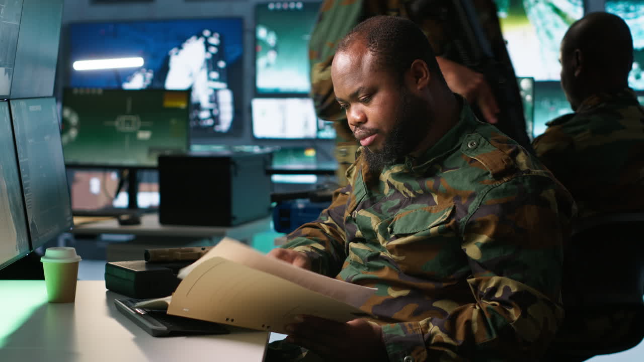 Army specialist overseeing national safety operations, reading folder files