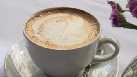 cup of cappuccino with flowers