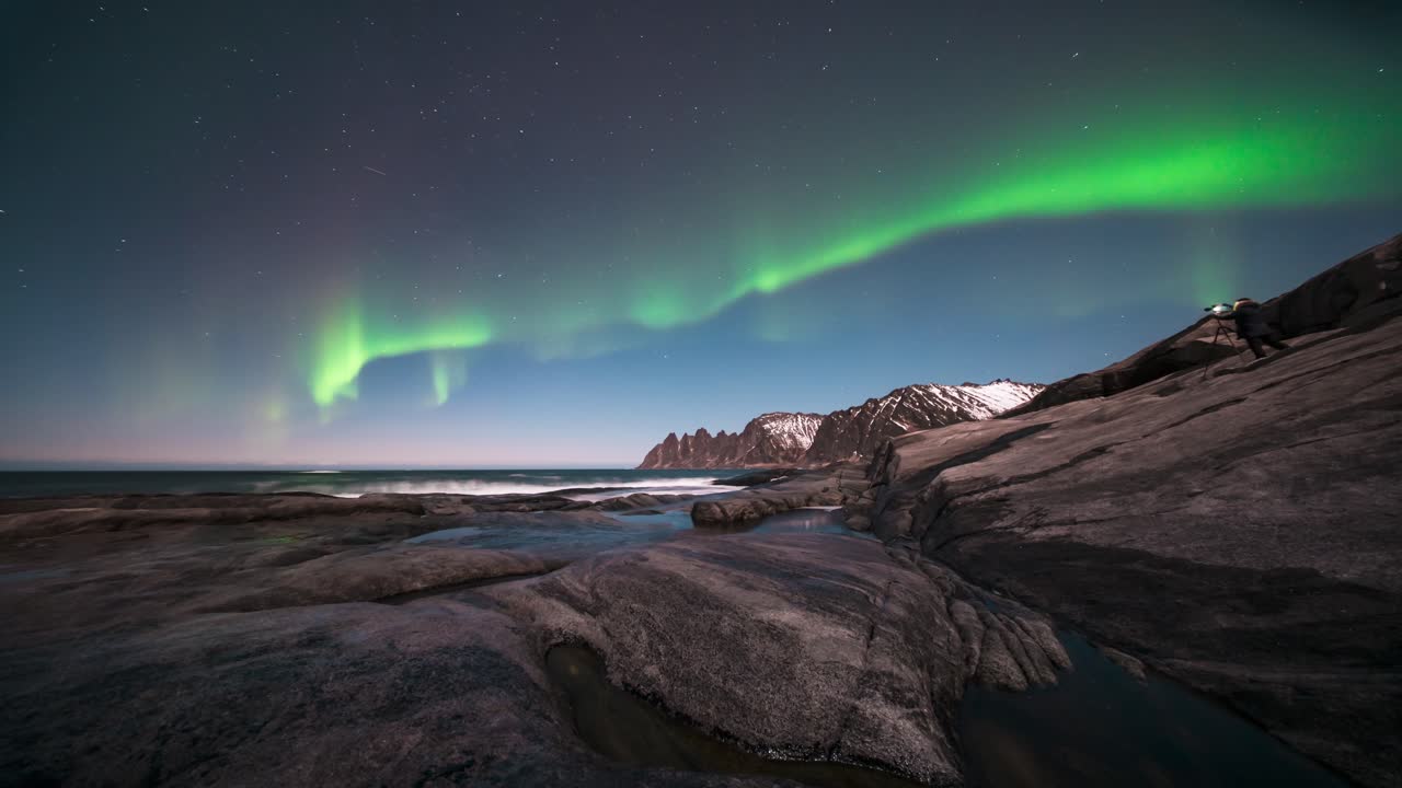 Northern lights dancing over rugged coastline at Tungeneset, stunning time-lapse shot