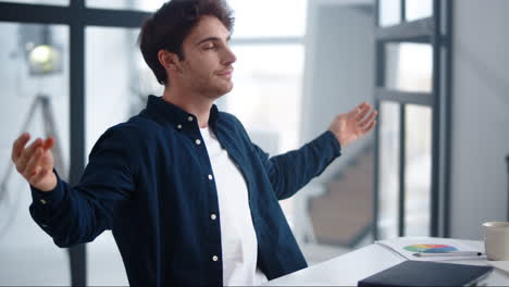 close-up view of handsome worker closing laptop in office