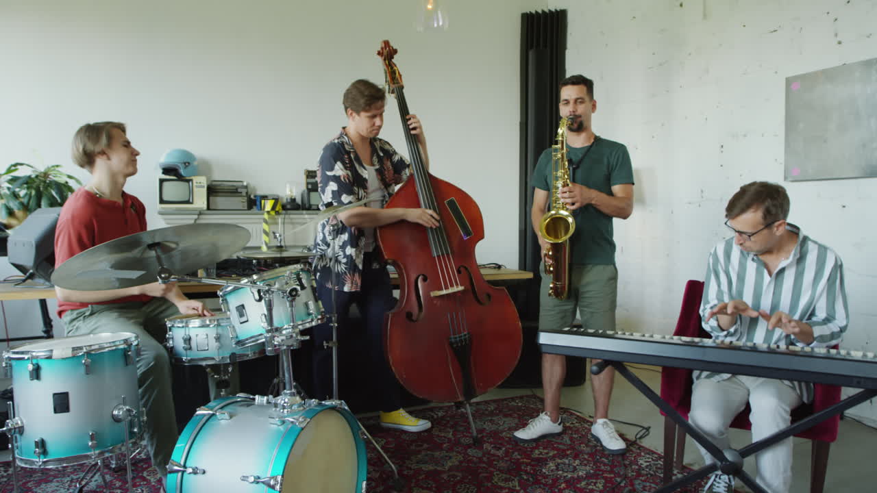 Four musicians playing various instruments in a band practice session