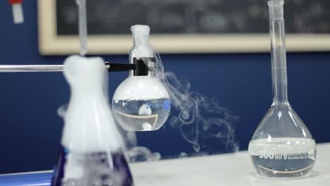 in a methodical slow-motion capture, glass beakers in a laboratory bubble vigorously, releasing white smoke, demonstrating the intricate processes and marvels of chemical research