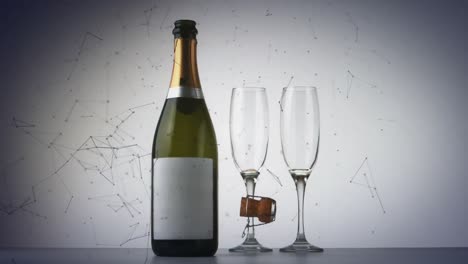 red de conexiones sobre una botella de champán y dos copas de champán contra un fondo gris