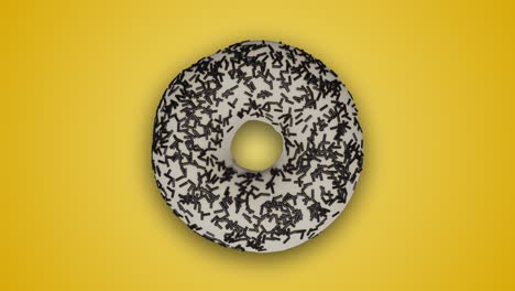varias deliciosas rosquillas esmaltadas girando y cambiando entre sí en un fondo amarillo abstracto