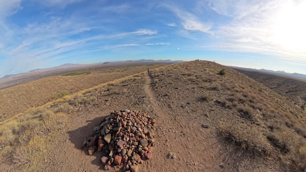 Red haired backpacker climbing a hill in the McDowell Mountain Regional Park.