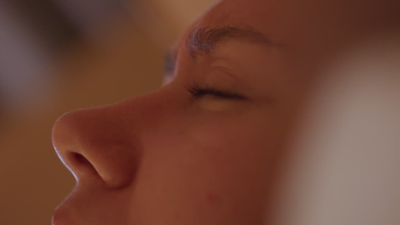 Travel restful nap. Quiet moment of sleep in hotel surroundings. Eyes shut in peaceful hotel evening by gentle lighting. Peaceful rest as traveler relaxes in softly illuminated hotel room