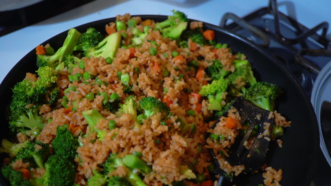 Vegetable stir fried rice with broccoli in frying pan, Overhead Detail Shot