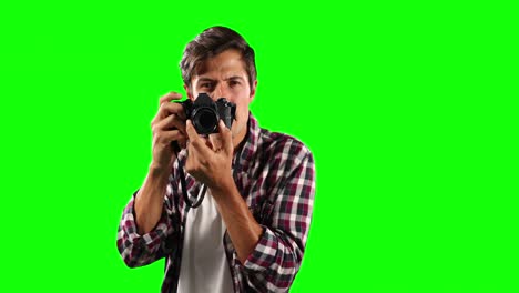Front-view-of-Caucasian-man-taking-photos-with-green-screen