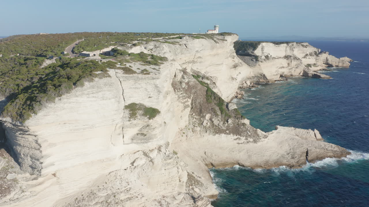Bonifacio, Corsica aerial drone shot cliffs at sunset lighthouse rugged coastline limestone the turquoise Mediterranean Sea iconic French island landscape