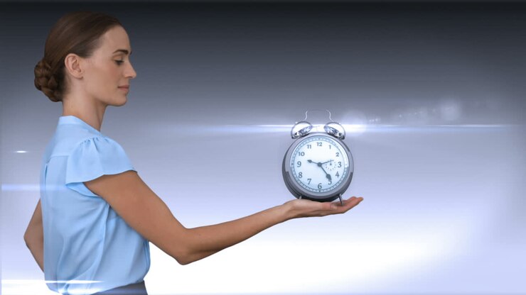 A businesswoman holding alarm clock