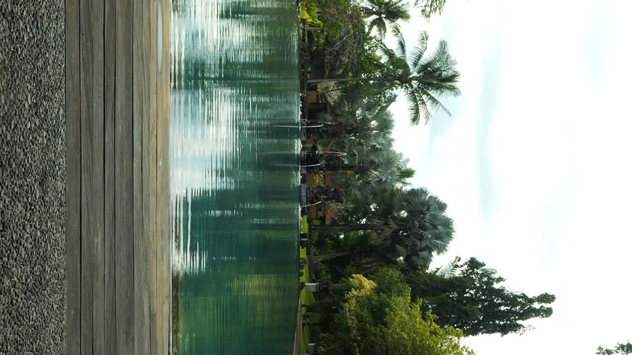 Inquadratura verticale di una splendida piscina in un hotel di lusso a Bali, Indonesia, durante una bellissima mattinata e un fantastico viaggio.
