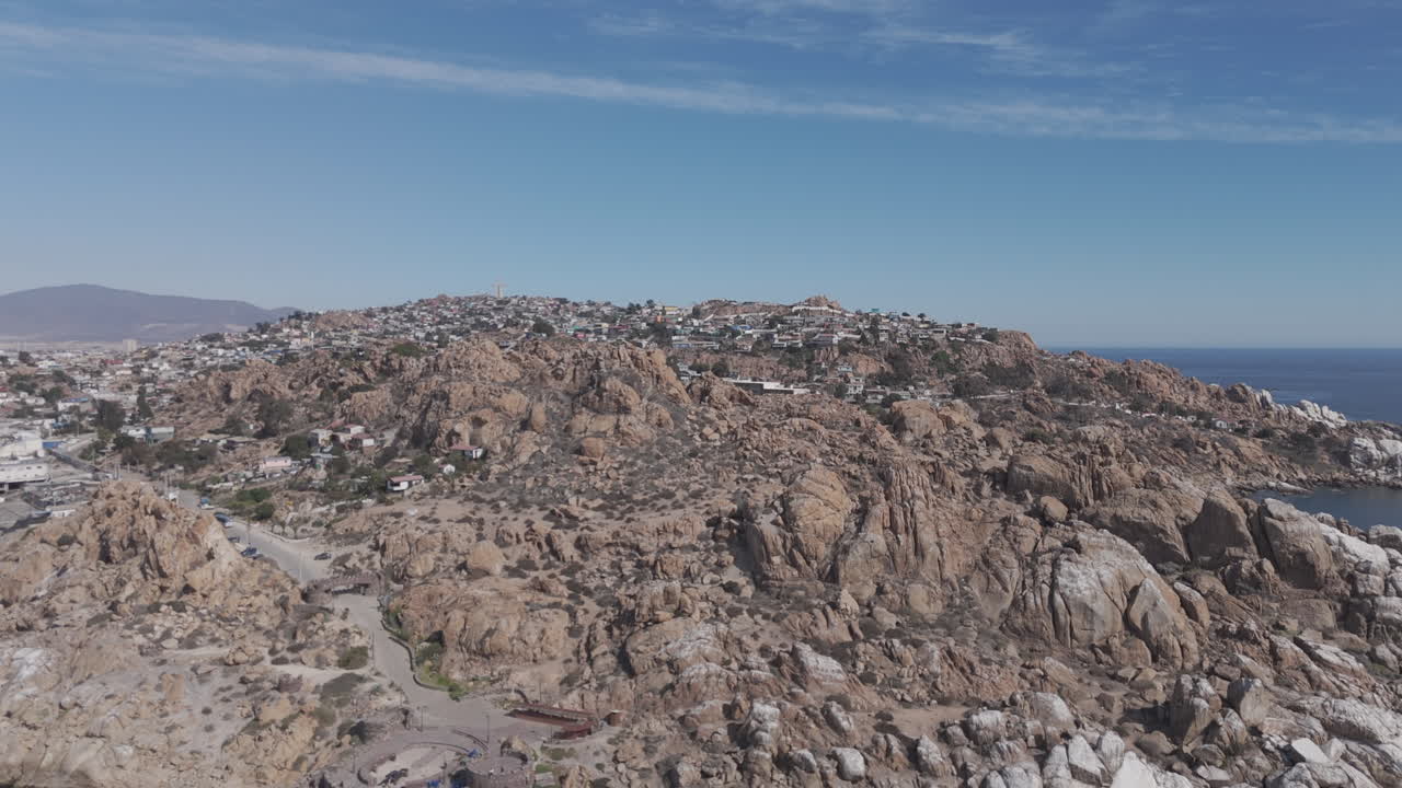 Drone shot of Coquimbo Chile South America on a blue sky day with a panoramic view of the city with mountains in the background LOG