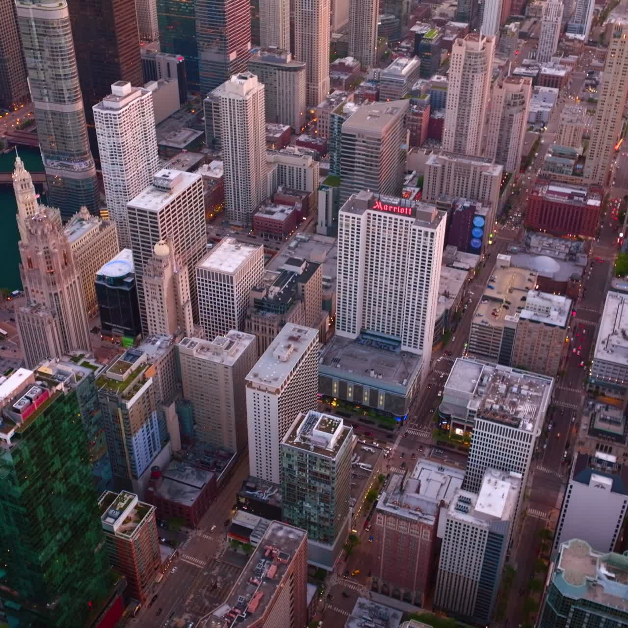 Famous landmarks of amazing Chicago, Illinois. Lively and vibrant streets of busy city at sundusk. Aerial perspective