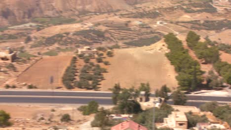 a car drives along a highway and we reveal to see the dead sea region of jordan