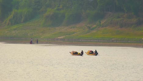 fishermen on wooden boats in a river