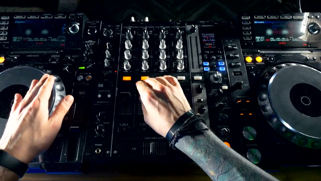 FOV. Mani di DJ che mixano a una festa in discoteca di notte