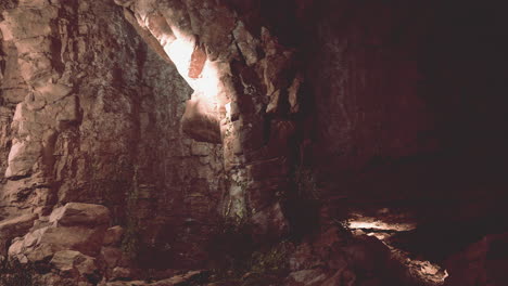 a narrow cave entrance with light shining through