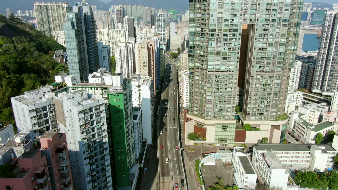 toma aérea de mega rascacielos residenciales y tráfico en el centro de hong kong, en un hermoso día